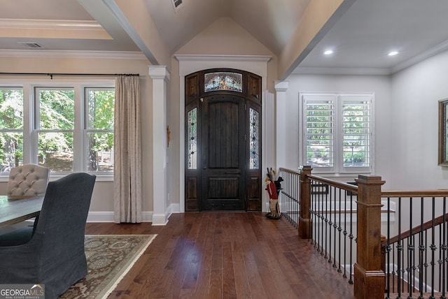 foyer with crown molding, visible vents, plenty of natural light, and hardwood / wood-style floors