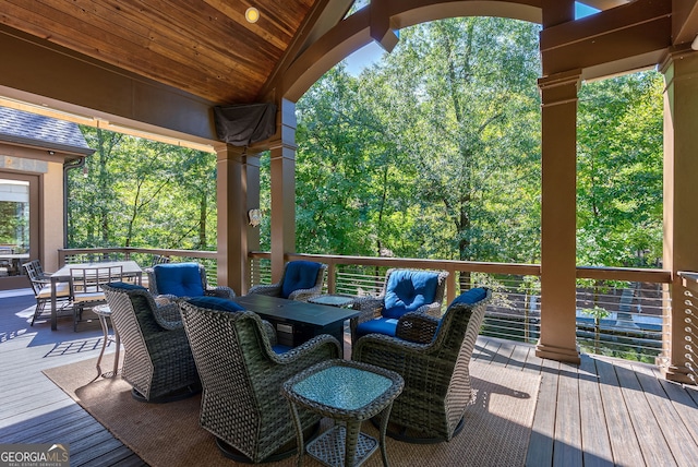 wooden terrace with outdoor dining space and outdoor lounge area