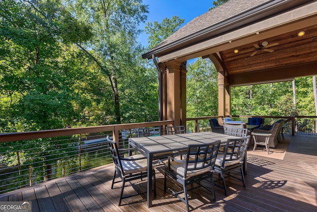 wooden deck featuring ceiling fan and outdoor dining space