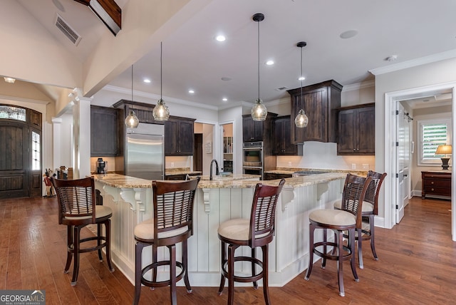 kitchen featuring decorative columns, visible vents, dark wood-style floors, appliances with stainless steel finishes, and dark brown cabinets