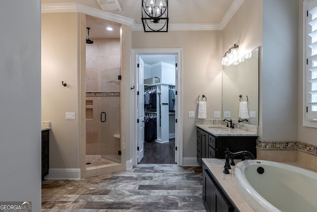 bathroom with a garden tub, a spacious closet, ornamental molding, a shower stall, and vanity