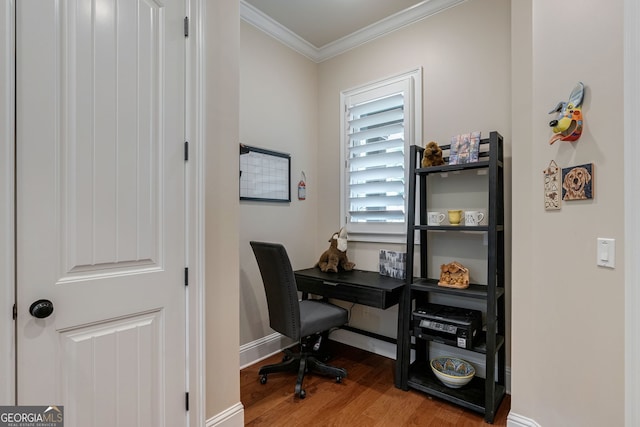 office space featuring baseboards, crown molding, and wood finished floors