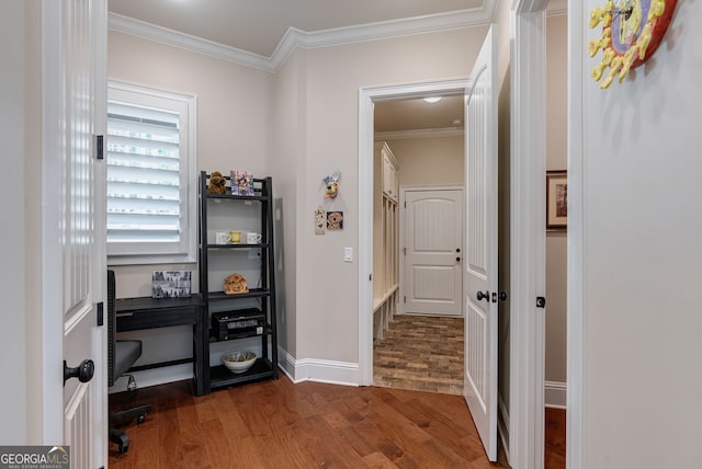 interior space featuring crown molding, baseboards, and wood finished floors