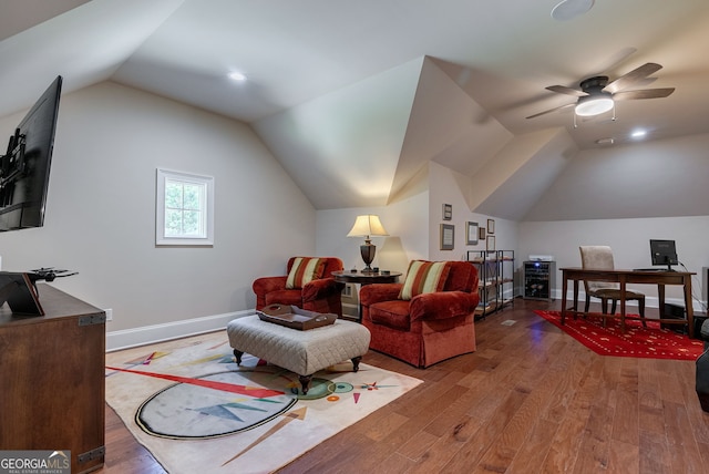 interior space featuring a ceiling fan, lofted ceiling, baseboards, and wood finished floors