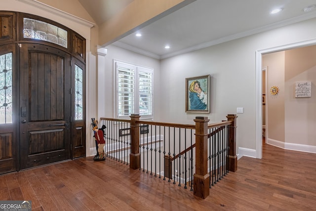 entrance foyer with baseboards, ornamental molding, wood finished floors, and recessed lighting