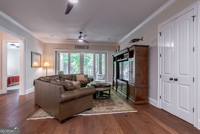 living room featuring ornamental molding, ceiling fan, baseboards, and wood finished floors