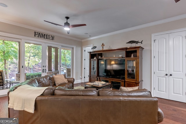 living area with crown molding, ceiling fan, and wood finished floors