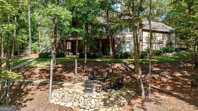 view of yard featuring a patio, an outdoor fire pit, and a wooden deck