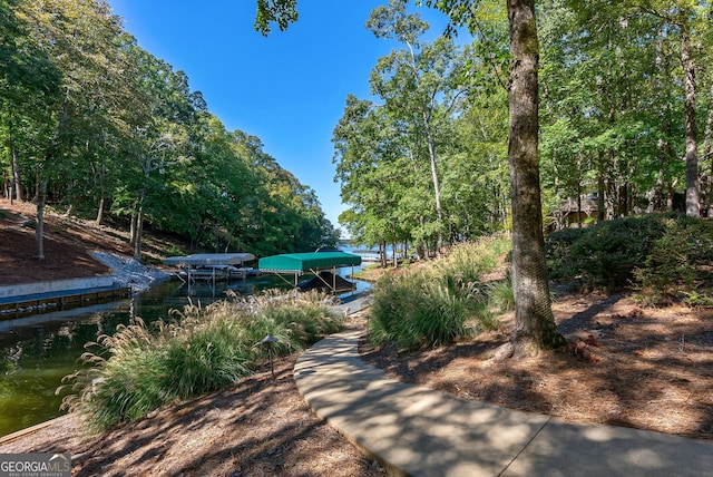 view of community featuring a dock and boat lift