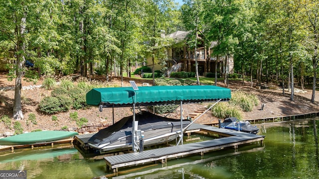 dock area with a water view, boat lift, and stairway