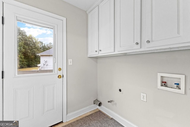 clothes washing area featuring cabinet space, baseboards, hookup for a gas dryer, hookup for a washing machine, and hookup for an electric dryer