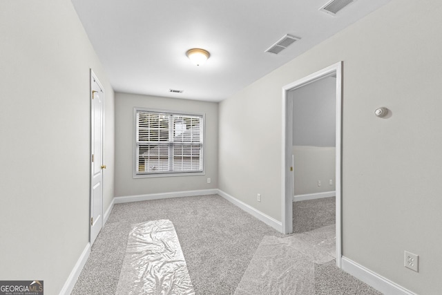 unfurnished room with baseboards, visible vents, and carpet flooring