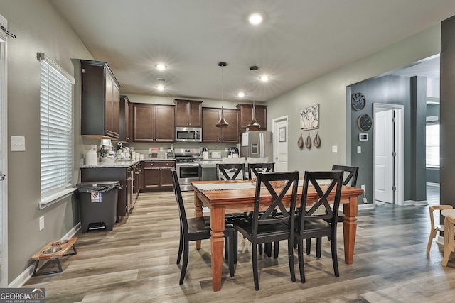 dining area featuring light wood-type flooring, baseboards, and recessed lighting