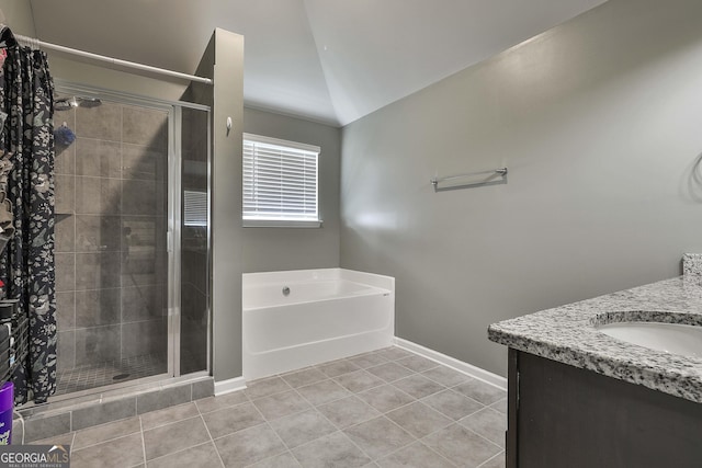 full bathroom with vaulted ceiling, tile patterned flooring, a garden tub, and a shower stall