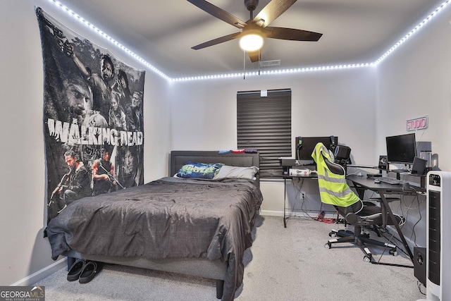 carpeted bedroom with baseboards, visible vents, and a ceiling fan