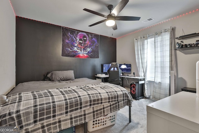 carpeted bedroom featuring visible vents and a ceiling fan