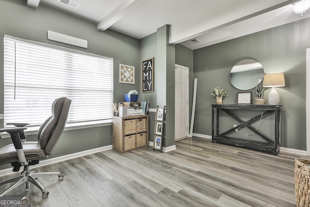 home office featuring visible vents, baseboards, and wood finished floors