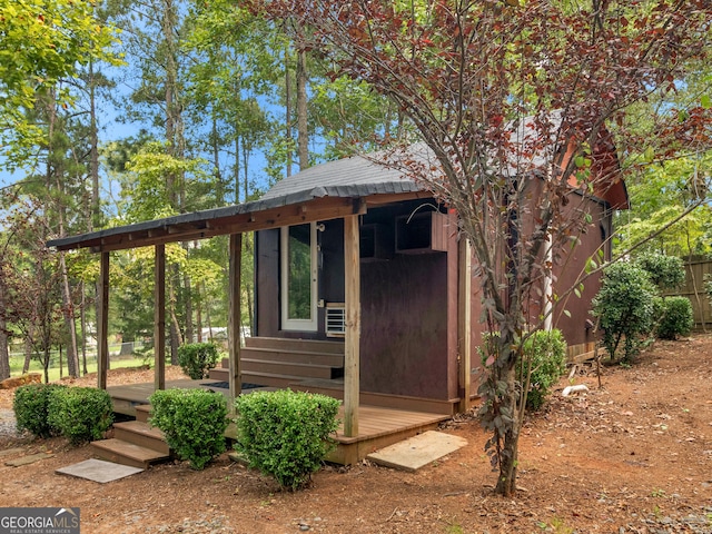 view of outbuilding featuring an outdoor structure and fence