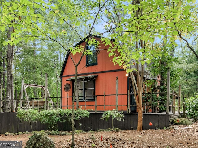 view of side of home with a barn