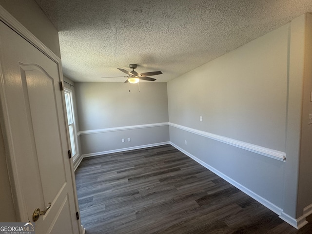 unfurnished bedroom featuring a textured ceiling, ceiling fan, dark wood finished floors, and baseboards