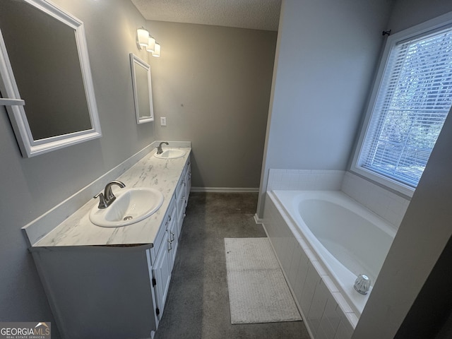 bathroom featuring a healthy amount of sunlight, a sink, and a textured ceiling