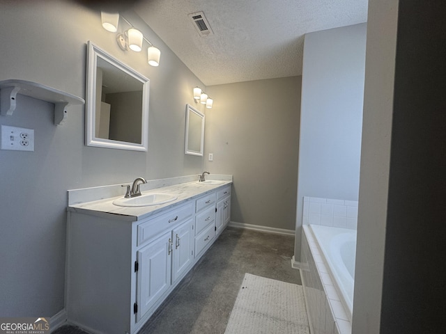 bathroom with double vanity, a textured ceiling, visible vents, and a sink