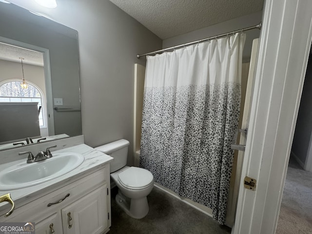 full bathroom featuring toilet, a textured ceiling, and vanity