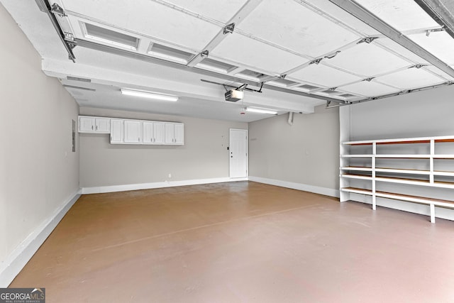 garage with baseboards and a garage door opener