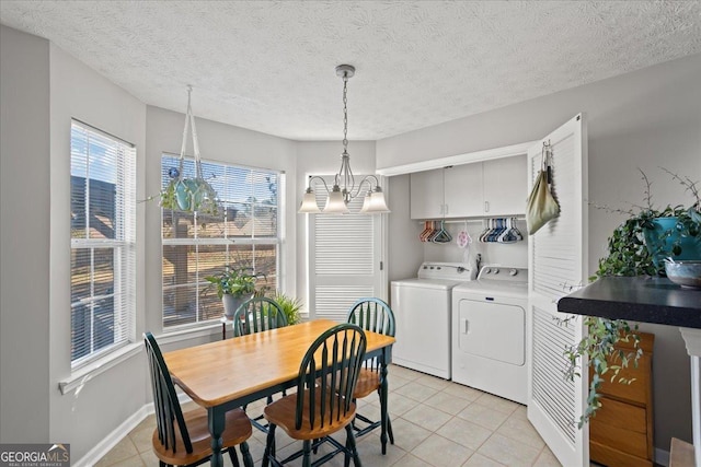 dining room with light tile patterned floors, washer and clothes dryer, a textured ceiling, and a notable chandelier