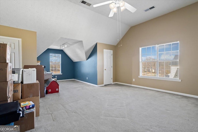 additional living space with vaulted ceiling, visible vents, and baseboards