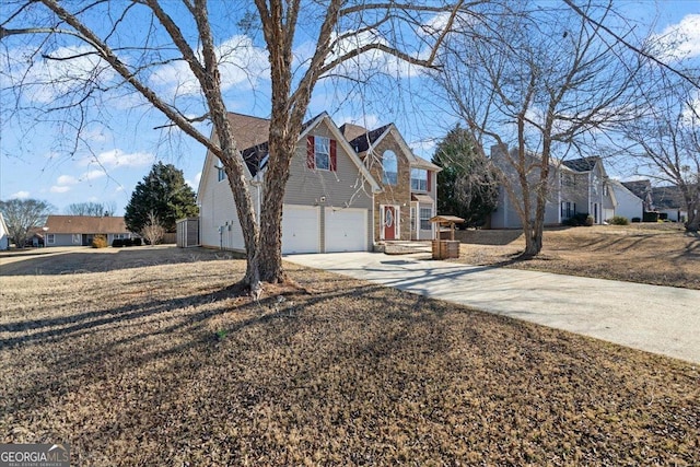 view of side of home featuring a garage, driveway, and a residential view