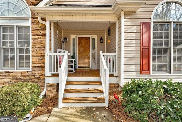 property entrance featuring stone siding