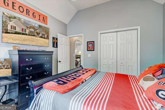 bedroom featuring lofted ceiling and a closet