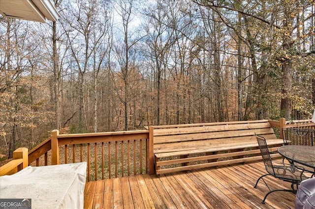 wooden deck with a forest view