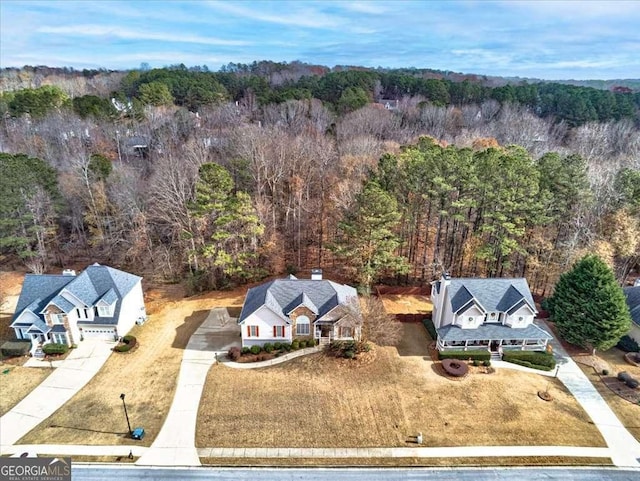 drone / aerial view with a wooded view