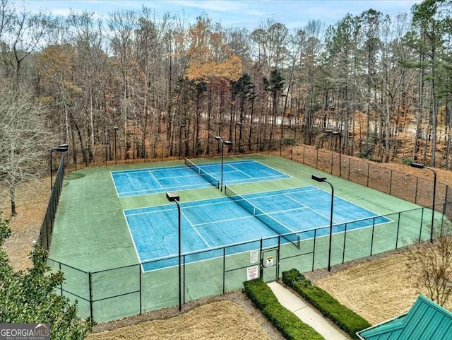 view of tennis court with fence