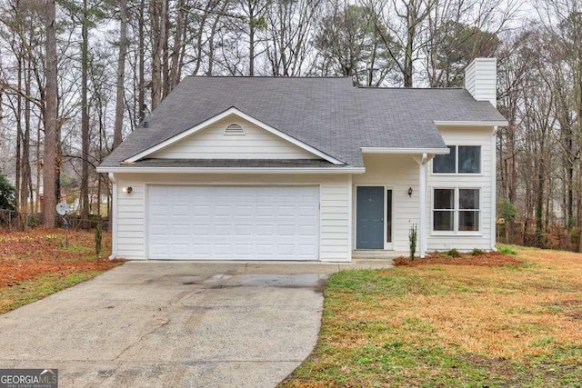 view of front of property with driveway, an attached garage, a chimney, and a front yard