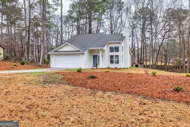 view of front of home featuring a garage, driveway, a chimney, and a shingled roof