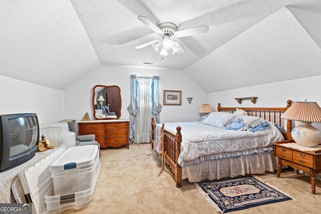 bedroom featuring a ceiling fan, lofted ceiling, light colored carpet, and a textured ceiling