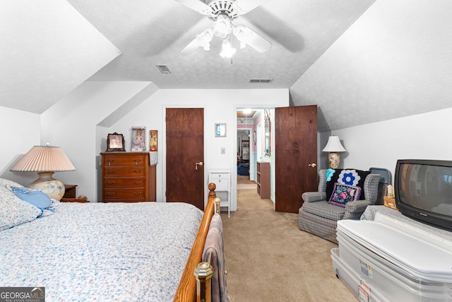 bedroom featuring light carpet, visible vents, a textured ceiling, and lofted ceiling