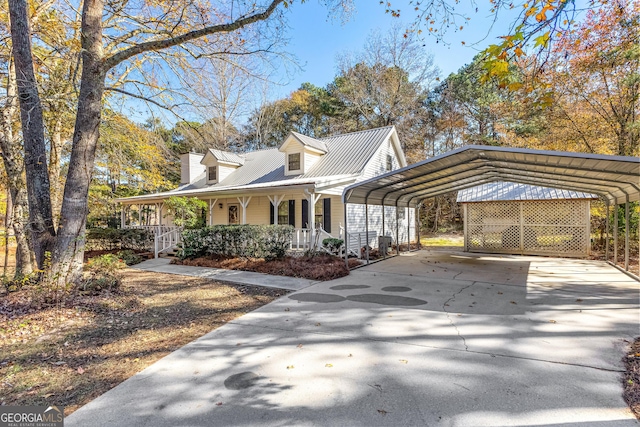 view of front of property featuring a carport, driveway, a porch, and metal roof