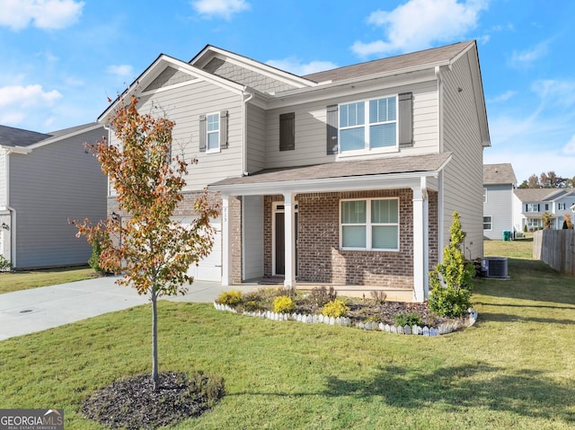 craftsman-style house with driveway, brick siding, an attached garage, central AC, and a front yard