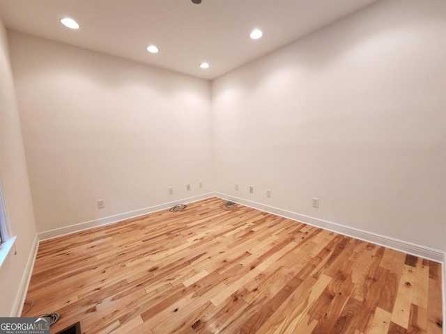 unfurnished room featuring recessed lighting, baseboards, and wood finished floors