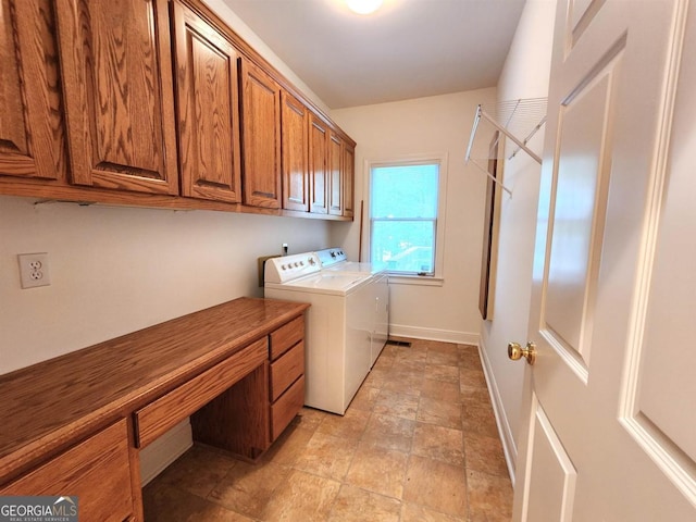 laundry area featuring baseboards, cabinet space, and washer and dryer