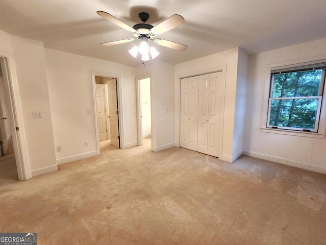 unfurnished bedroom featuring a closet, light carpet, ceiling fan, and baseboards