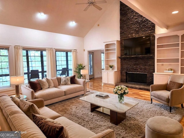 living area with ceiling fan, wood finished floors, a fireplace, high vaulted ceiling, and recessed lighting