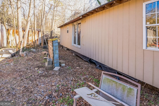 view of side of property featuring fence