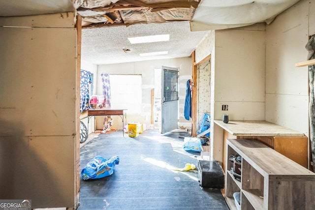 interior space featuring a textured ceiling and a workshop area