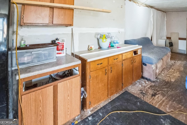 kitchen with brown cabinetry and light countertops