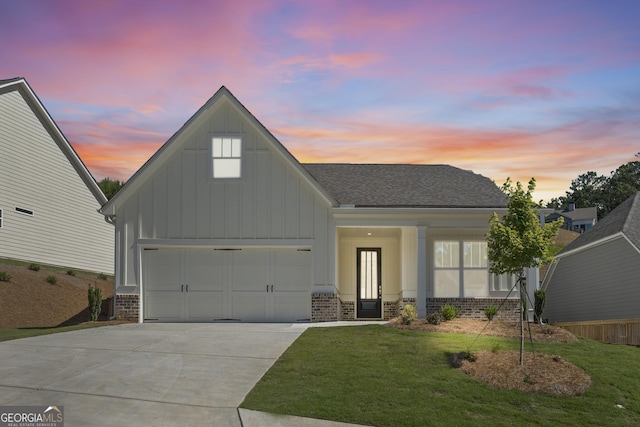 view of front facade with driveway, a garage, brick siding, board and batten siding, and a front yard